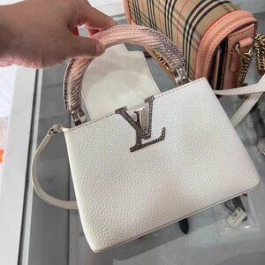 Authentic Louis Vuitton white handbag purchased from a counter